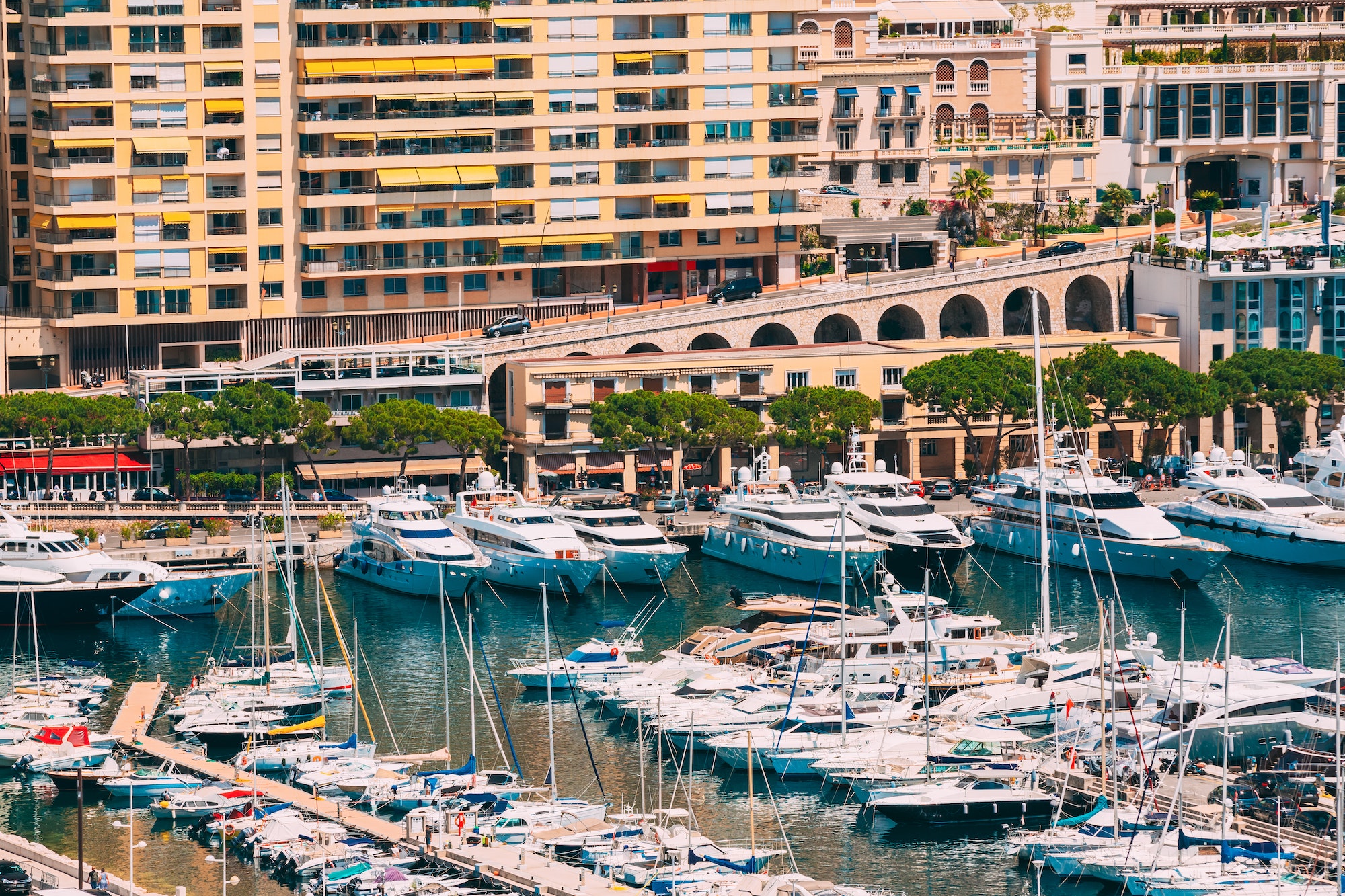 Monaco, Monte Carlo. Yachts Moored Near City Pier, Jetty In Sunn